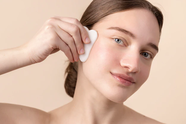 side-view-young-model-using-gua-sha_23-2149427927.jpg